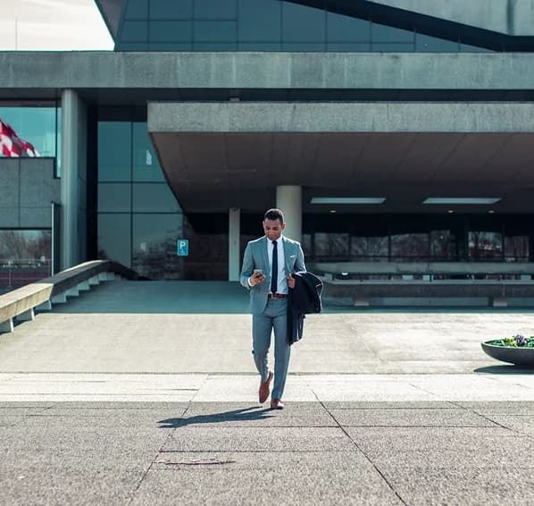 Man in suit walking outside modern building